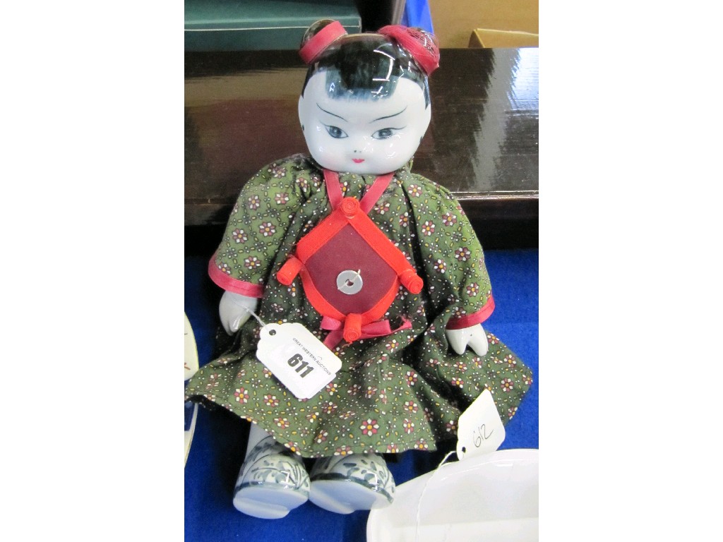 Appraisal: Oriental doll with pottery head hands and feet