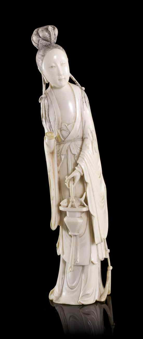 Appraisal: A Chinese Carved Ivory Figure of a Lady depicted holding