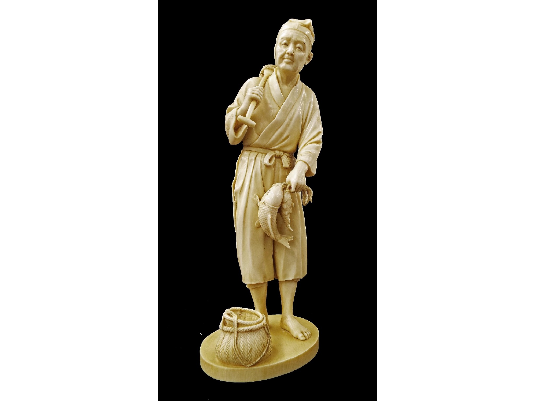 Appraisal: Japanese ivory okimono finely carved and modelled as a fisherman