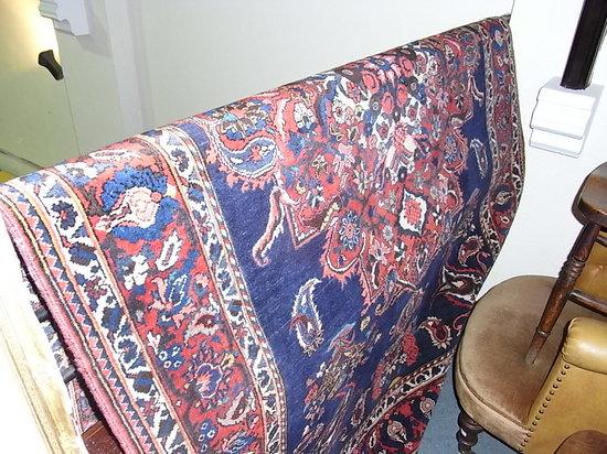 Appraisal: A PAKISTAN BLUE GROUND RUG with central red foliate and