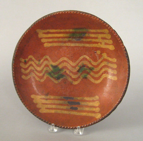 Appraisal: Redware charger th c with yellow slip and green splash