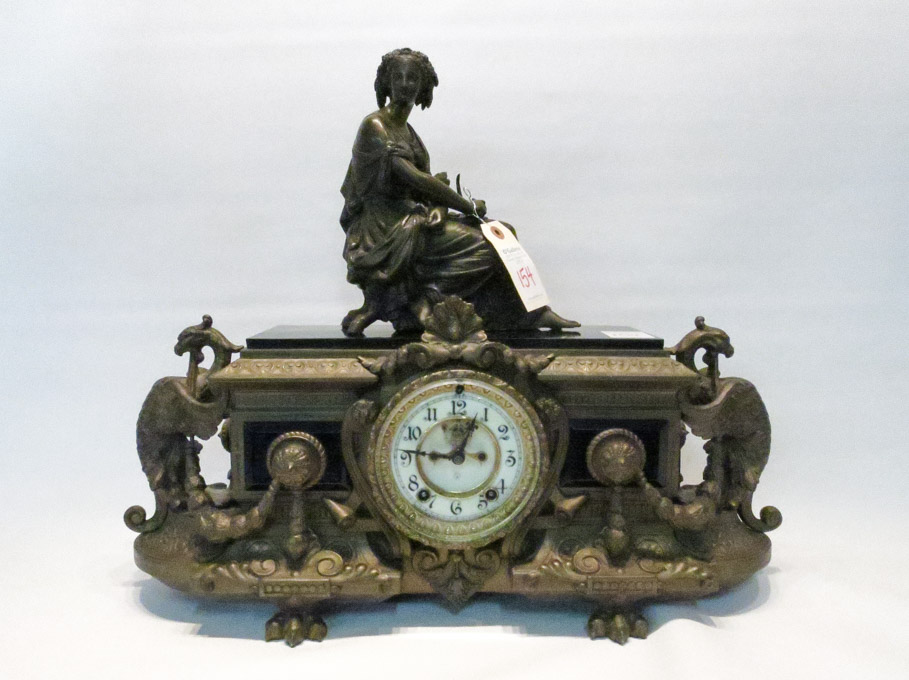 Appraisal: AMERICAN FIGURAL MANTEL CLOCK the ornate case of bronzed spelter