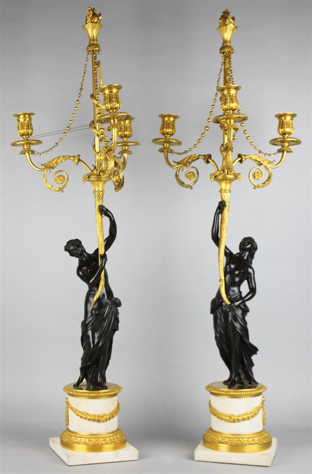 Appraisal: PAIR OF LOUIS XVI GILT BRONZE AND CARRARA MARBLE THREE-LIGHT