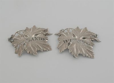 Appraisal: A pair of Victorian vine leaf wine labels pierced 'WHISKEY'