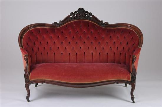 Appraisal: ROCOCO REVIVAL ROSEWOOD SOFA th century Finger-molded frame crested with