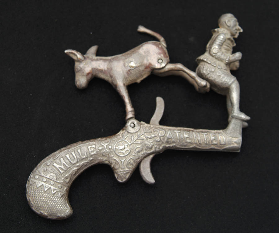 Appraisal: IVES CLOWN AND MULE ANIMATED CAP PISTOL Intricately cast gun