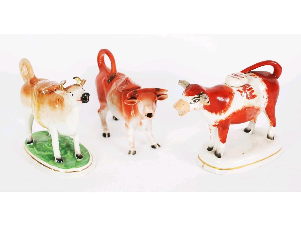 Appraisal: TWO STAFFORDSHIRE POTTERY COW CREAMERS with covers one in burnt