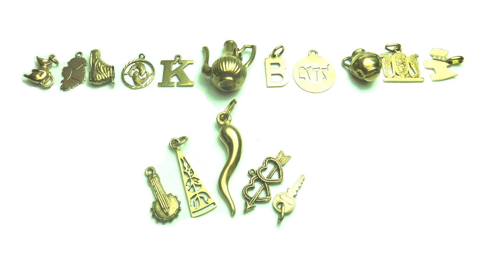 Appraisal: Sixteen mostly ct gold pendants and charms including a coffee