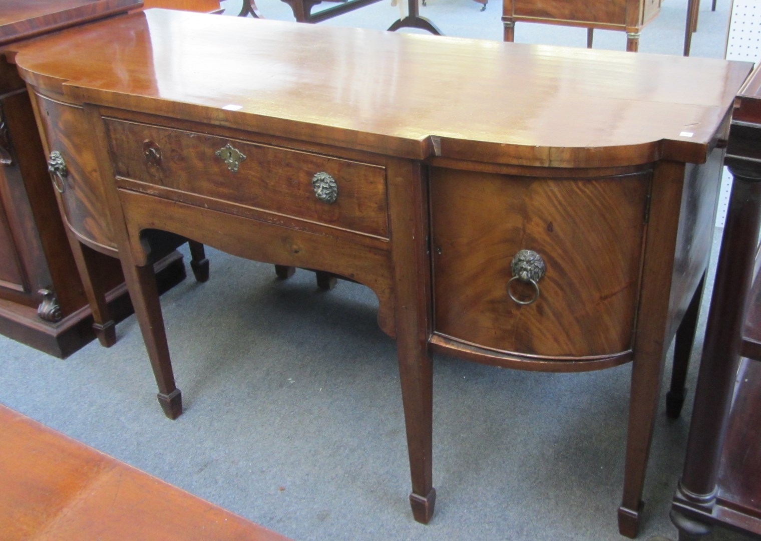 Appraisal: An early th century mahogany breakfront three drawer sideboard on