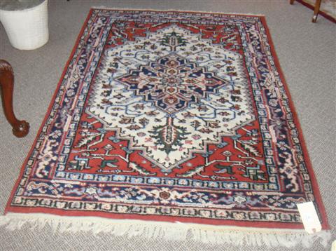 Appraisal: HANDWOVEN - INDIA RED CREAM BLUE AND PINK RUG WITH