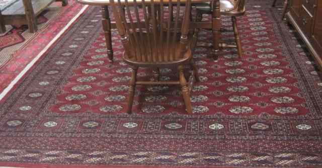 Appraisal: RED BOKHARA CARPET hand knotted in an overall Turkoman gol