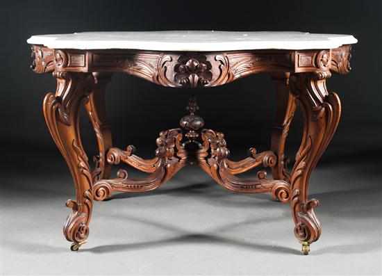 Appraisal: Rococo Revival carved walnut marble-top center table circa elaborately carved