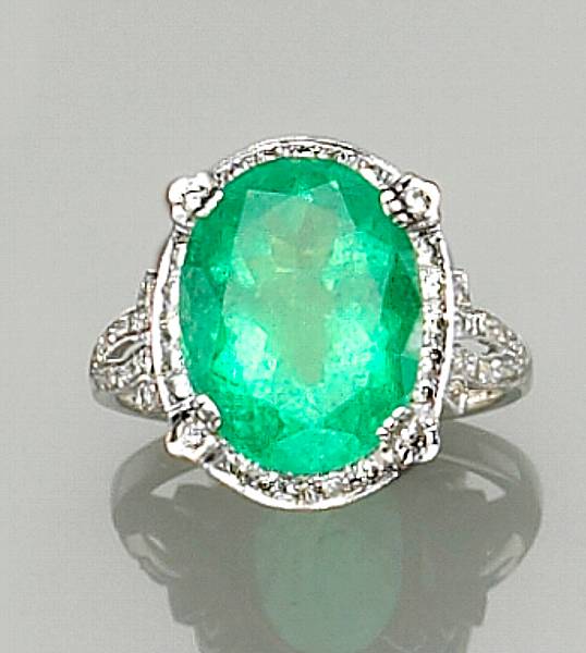 Appraisal: centering an oval-shaped emerald weighing carats framed by round brilliant-cut