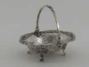 Appraisal: A George II silver swing handled sweetmeats basket with cast