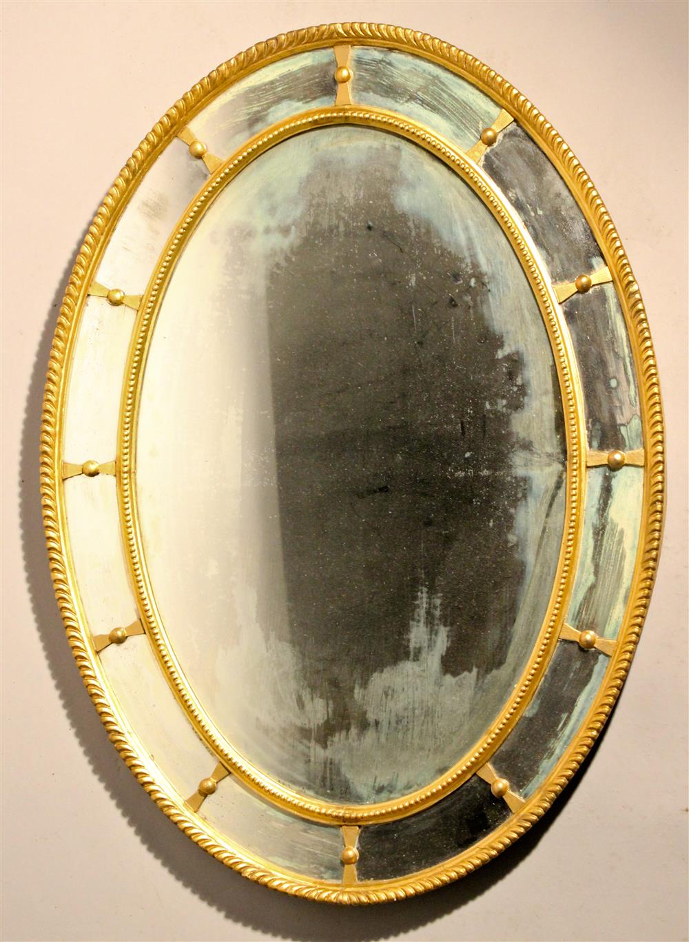 Appraisal: FRENCH OVAL GESSO AND GILT MIRROR CIRCA the carved rope-like