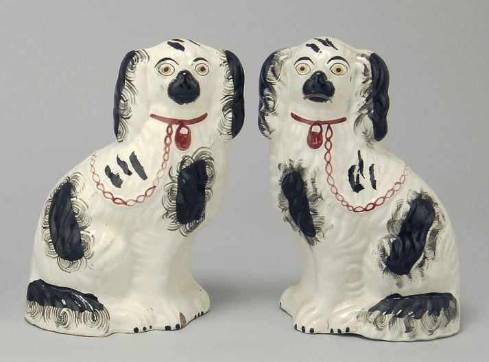 Appraisal: PAIR OF STAFFORDSHIRE POTTERY SPANIELS th CenturyIn black and white