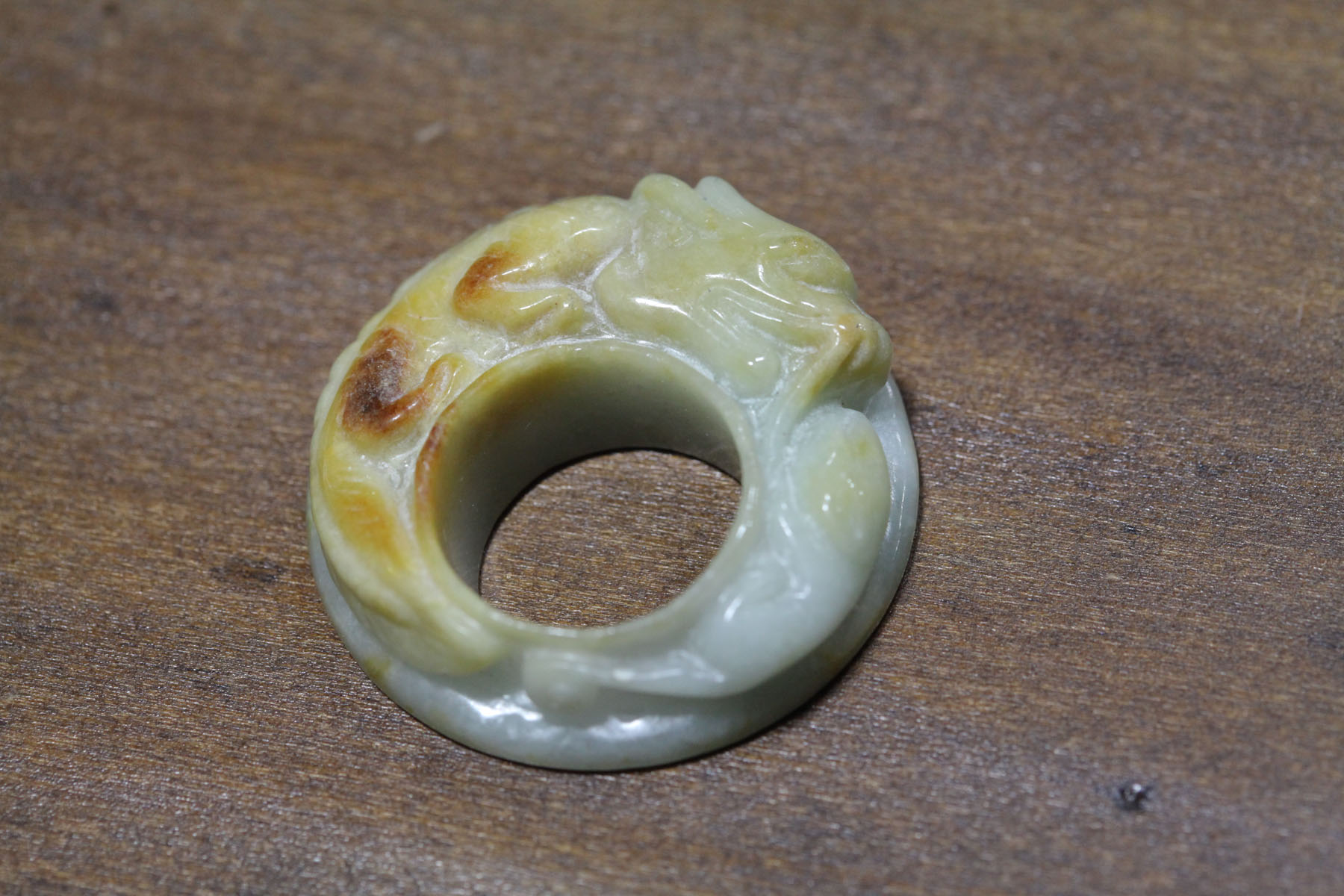 Appraisal: CARVED DISK Asian th century probably jade Pale green and