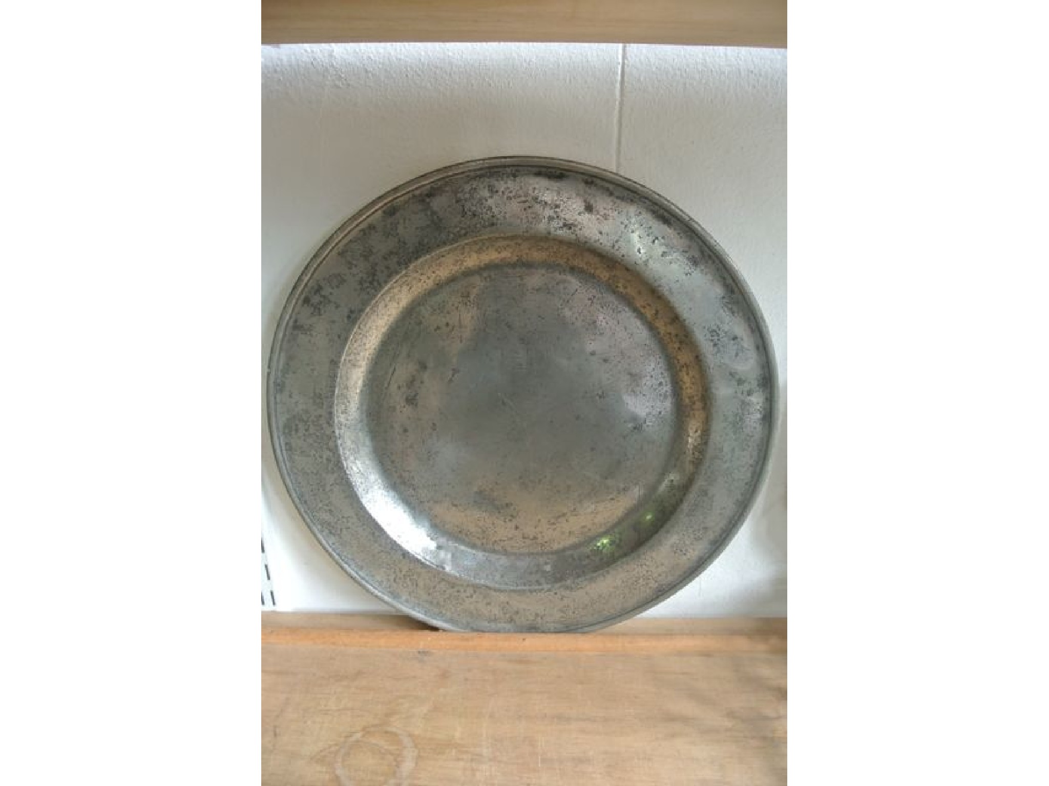 Appraisal: A pewter charger with simple bordered rim bearing three indistinct