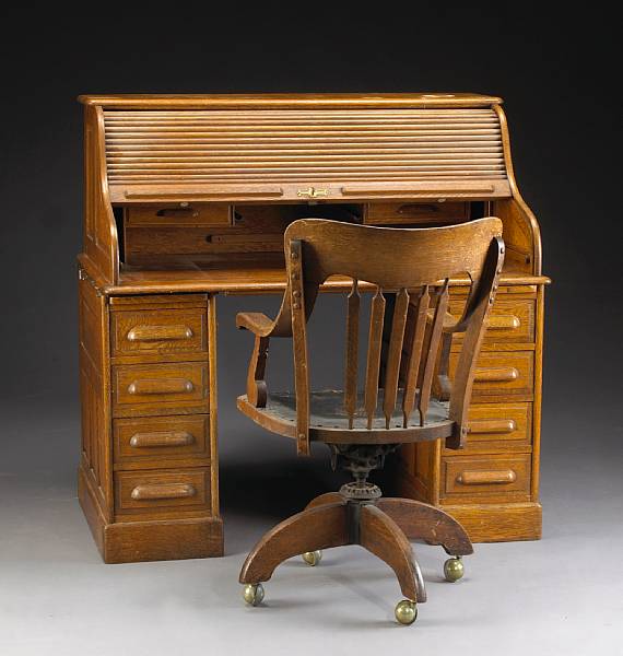 Appraisal: An American oak rolltop desk together with a swivel chair