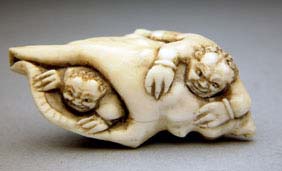 Appraisal: ANTIQUE IVORY NETSUKE Antique carved ivory netsuke of a conch