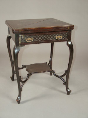 Appraisal: An Edwardian mahogany envelope card table with frieze drawer upon