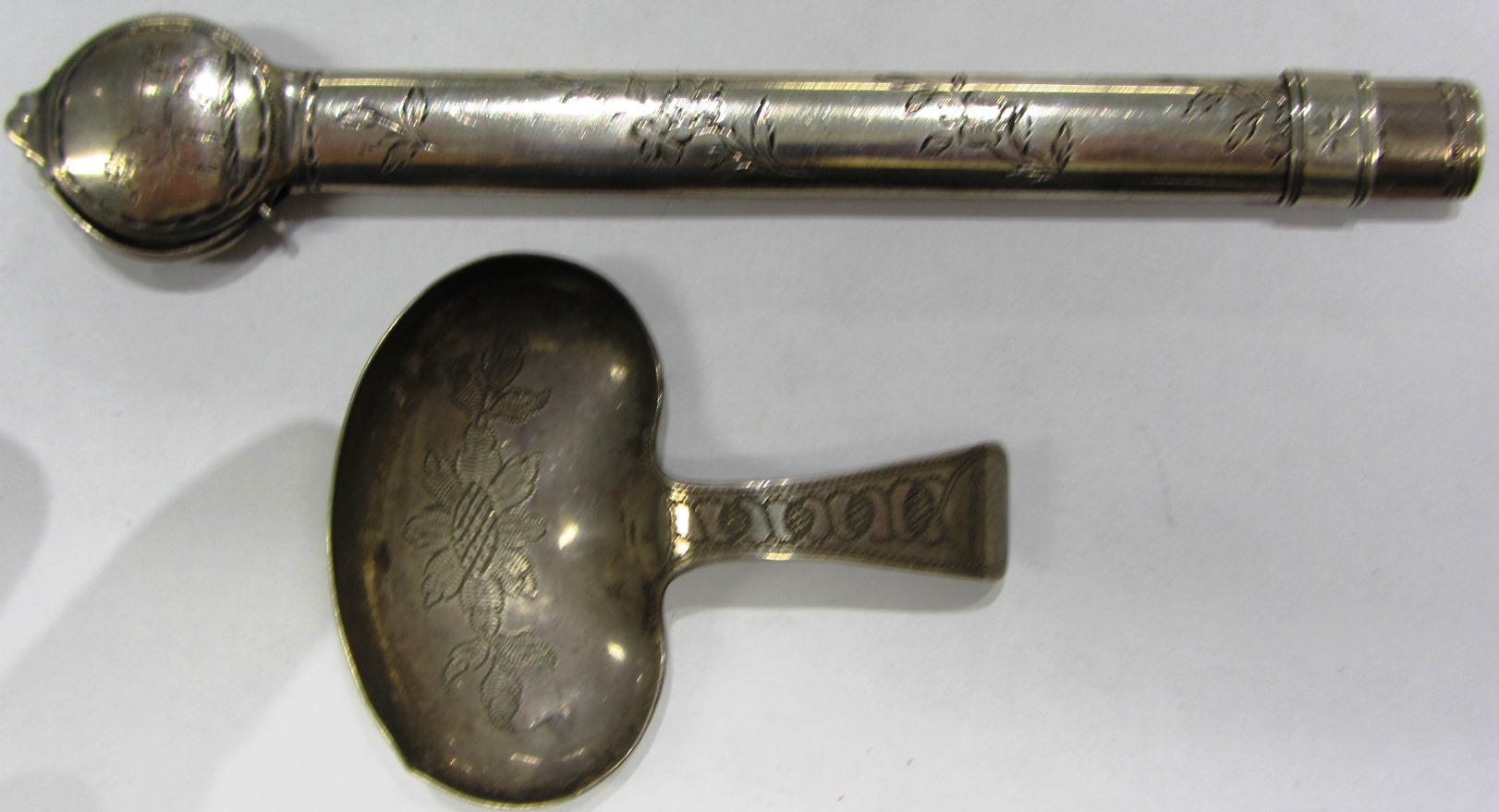 Appraisal: An oval cased slide action pencil with floral engraved decoration