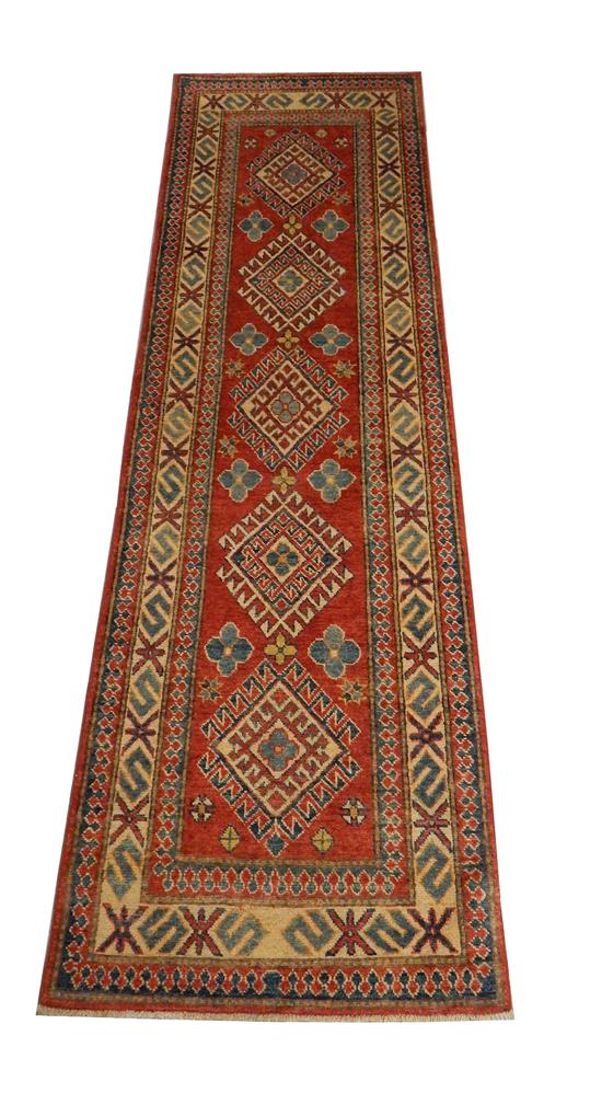 Appraisal: RUG Uzbek Kazak runner ' x ' brick red field