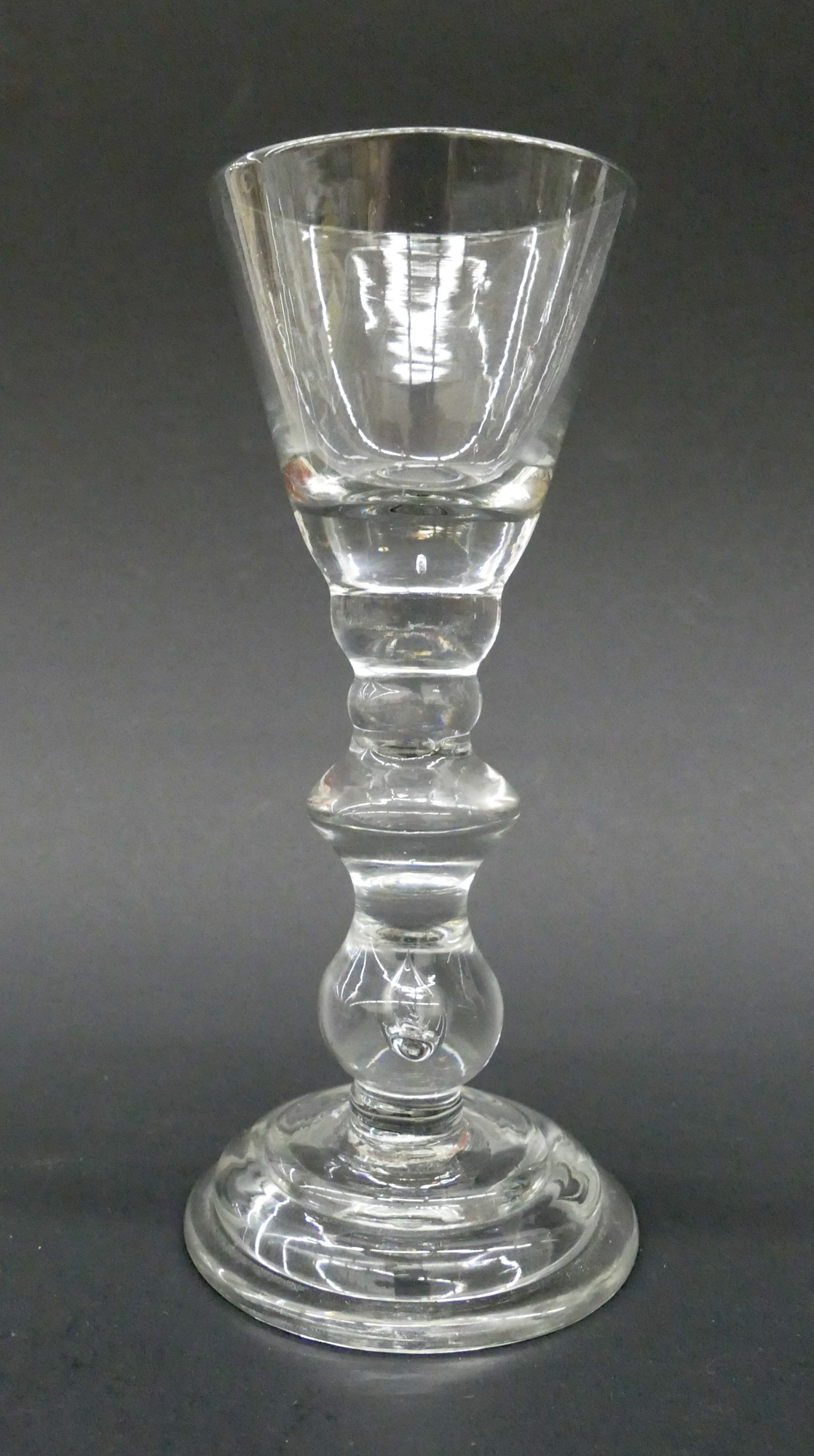 Appraisal: English Baluster Wine Glass c Funnel bowl angular central knop