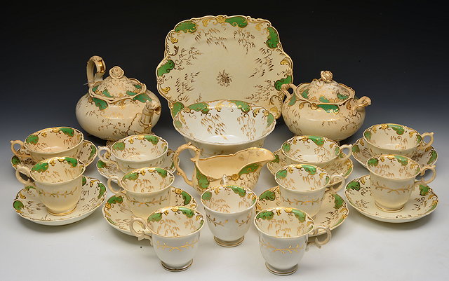 Appraisal: A TH CENTURY ROCKINGHAM STYLE PORCELAIN TEA SERVICE with apple