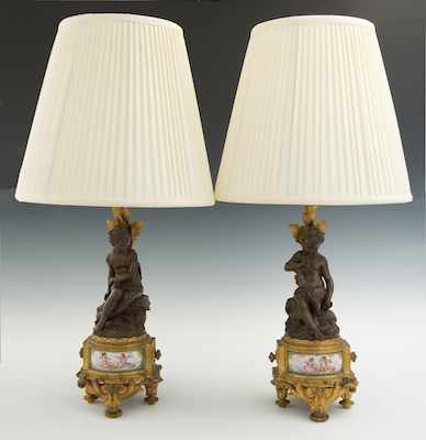 Appraisal: A Pair of Bronze and Porcelain Figural Lamps The bases