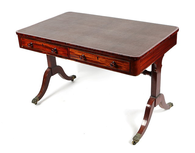 Appraisal: A REGENCY MAHOGANY LIBRARY TABLE with leatherette inset top two