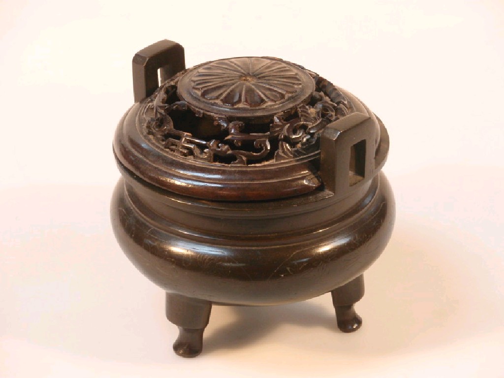 Appraisal: A thC Chinese bronze censer on three feet now with