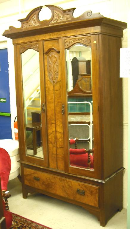 Appraisal: Edwardian walnut wardrobe the foliate carved broken arch pediment over