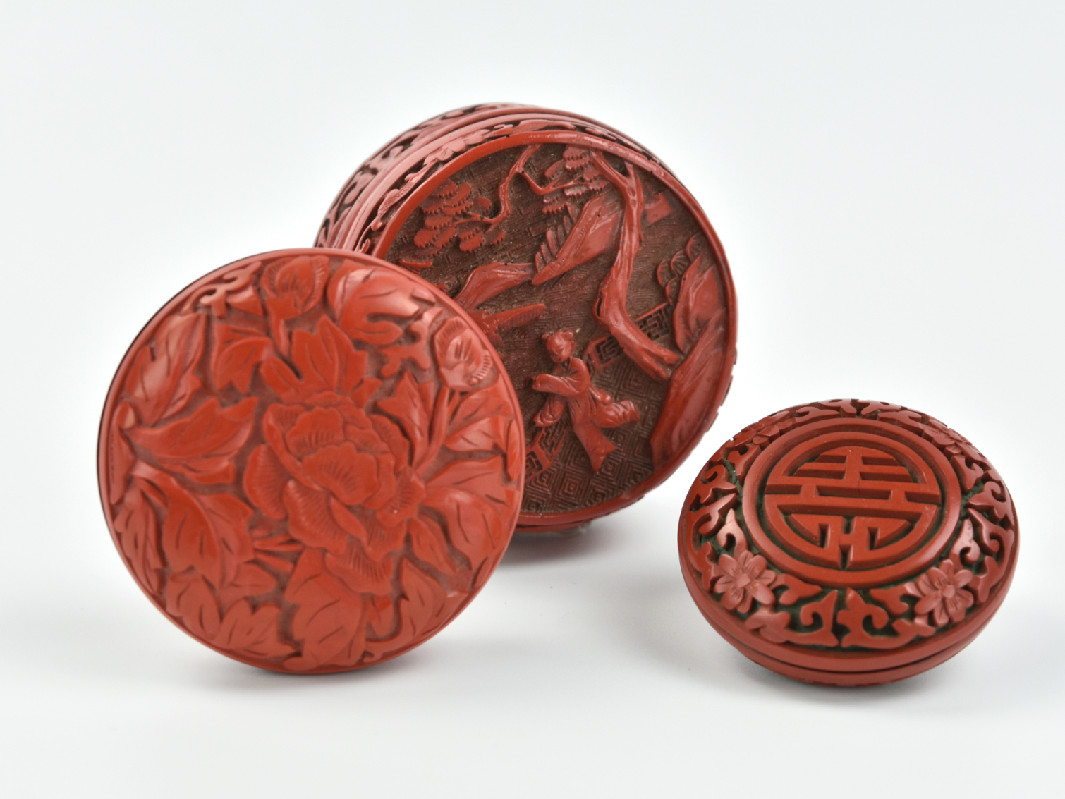 Appraisal: rounded red lacquer wood boxes with floral and foliage scroll