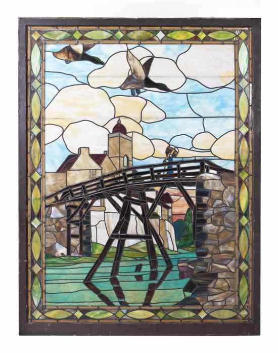 Appraisal: An American Leaded Glass Landscape Window depicting a bridge over