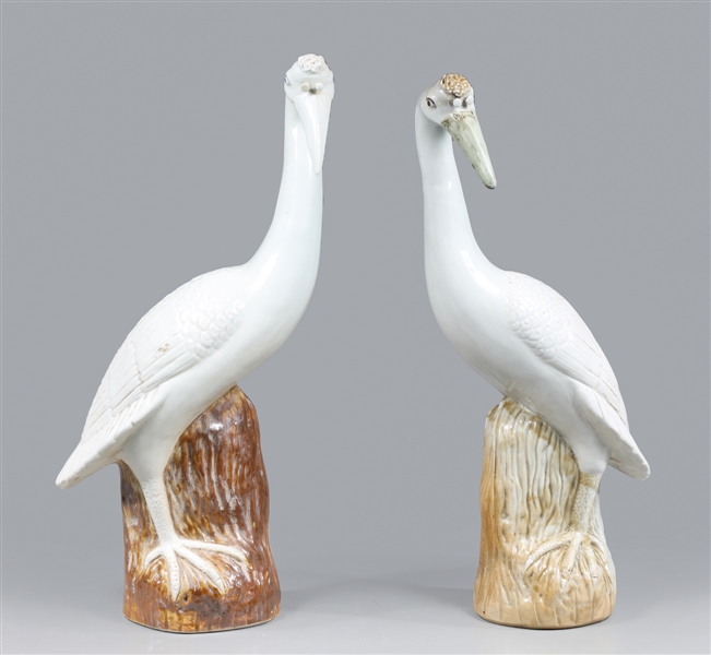 Appraisal: Pair of Chinese porcelain birds each standing atop brown glazed