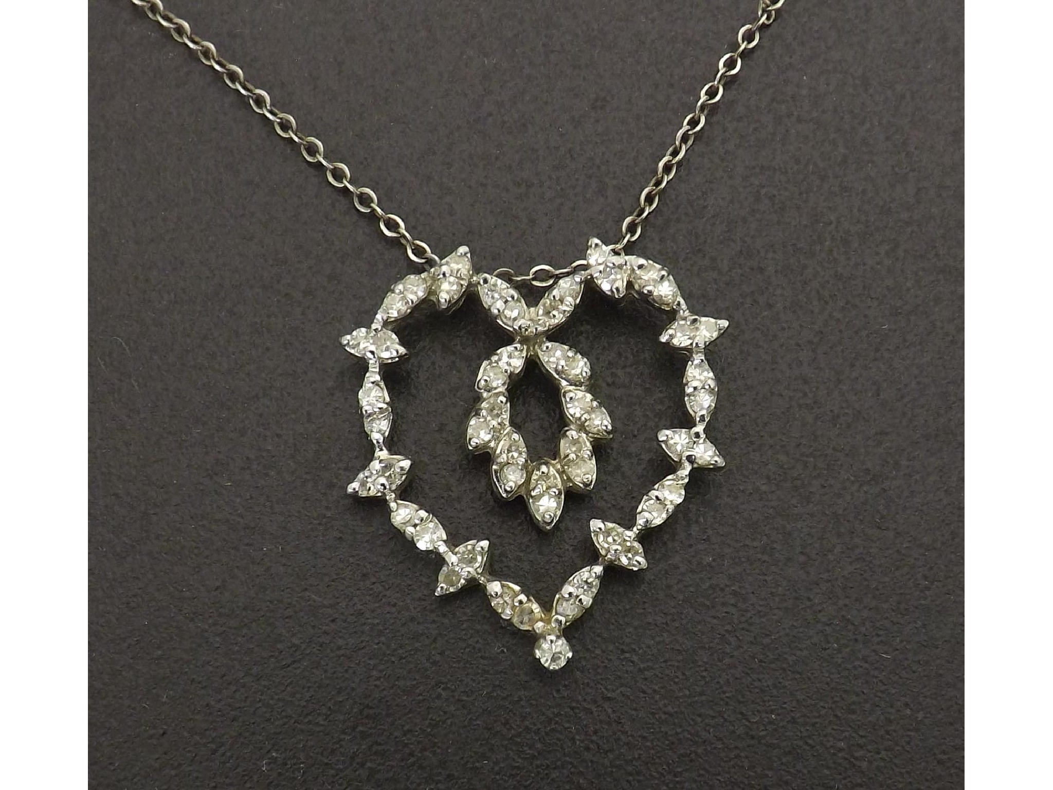 Appraisal: Delicate diamond heart shaped open pendant with round-cut diamonds in