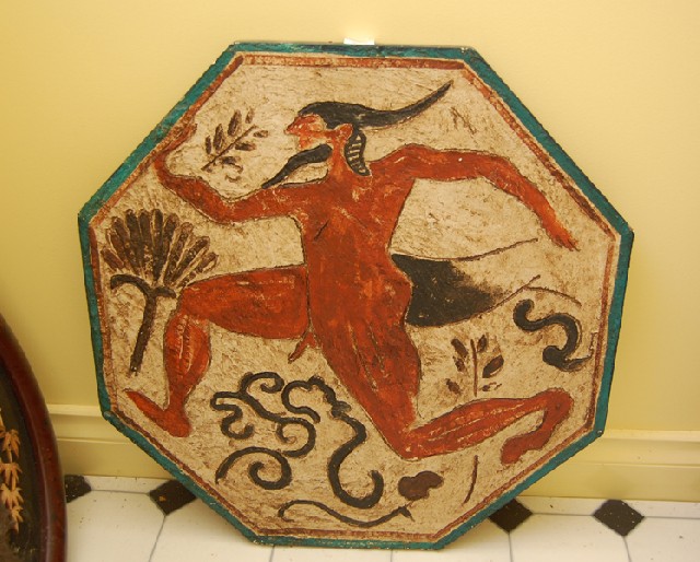 Appraisal: AN OCTAGONAL ARCHAIC STYLE WALL PLAQUE