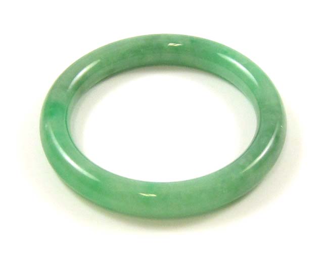 Appraisal: HEAVY GREEN JADE BANGLE The round jade bangle weighs grams