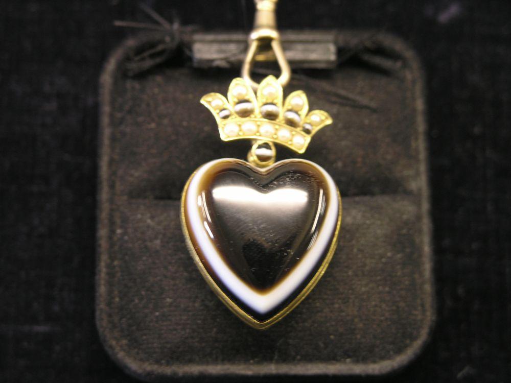 Appraisal: A banded agate pendant-locket heart shape pendant-locket beneath coronet set