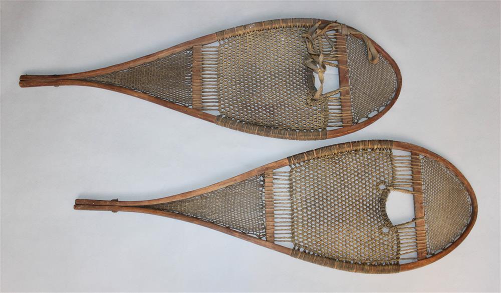 Appraisal: PAIR OF VINTAGE HANDMADE BENT WOOD AND LACED RAWHIDE SNOWSHOES