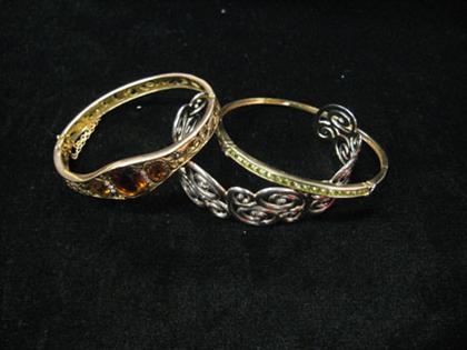 Appraisal: Three bracelets yellow gold and silver Two gold bangles one