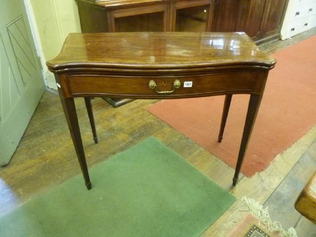 Appraisal: A Georgian mahogany fold over top card table with serpentine