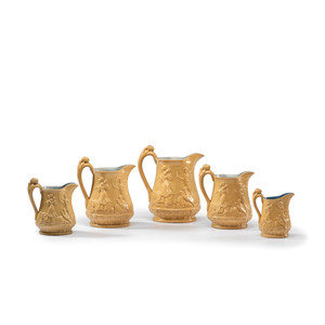 Appraisal: Five Graduated Abolitionist Yellowware Pitchers with Molded Scenes from Uncle