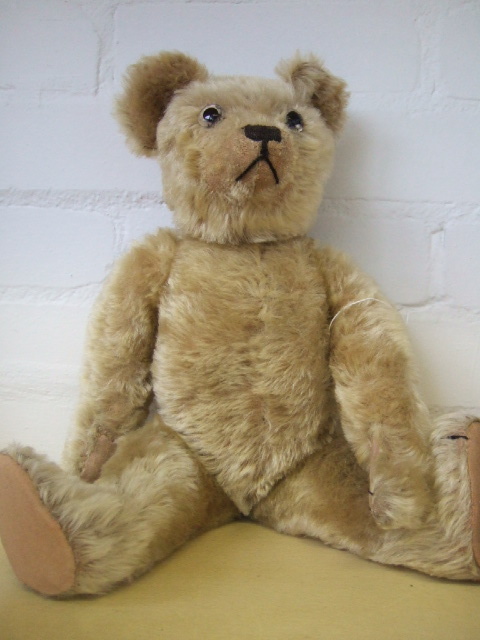 Appraisal: An early th century straw filled golden haired teddy bear