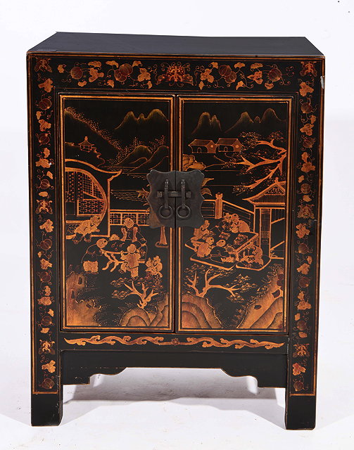 Appraisal: AN ORIENTAL BLACK LACQUERED SIDE CABINET the doors decorated with