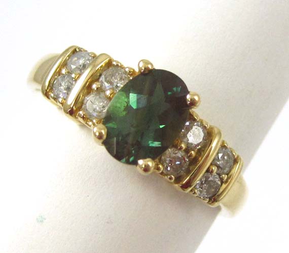 Appraisal: MYSTIC TOPAZ DIAMOND AND FOURTEEN KARAT GOLD RING with four