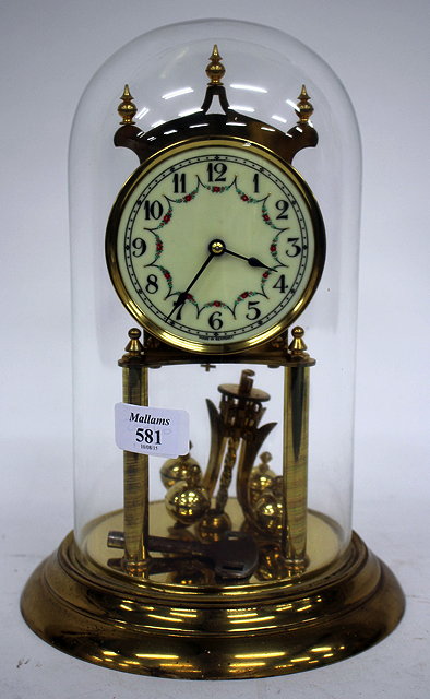 Appraisal: A GERMAN ANNIVERSARY CLOCK with turned finials the enamel dial