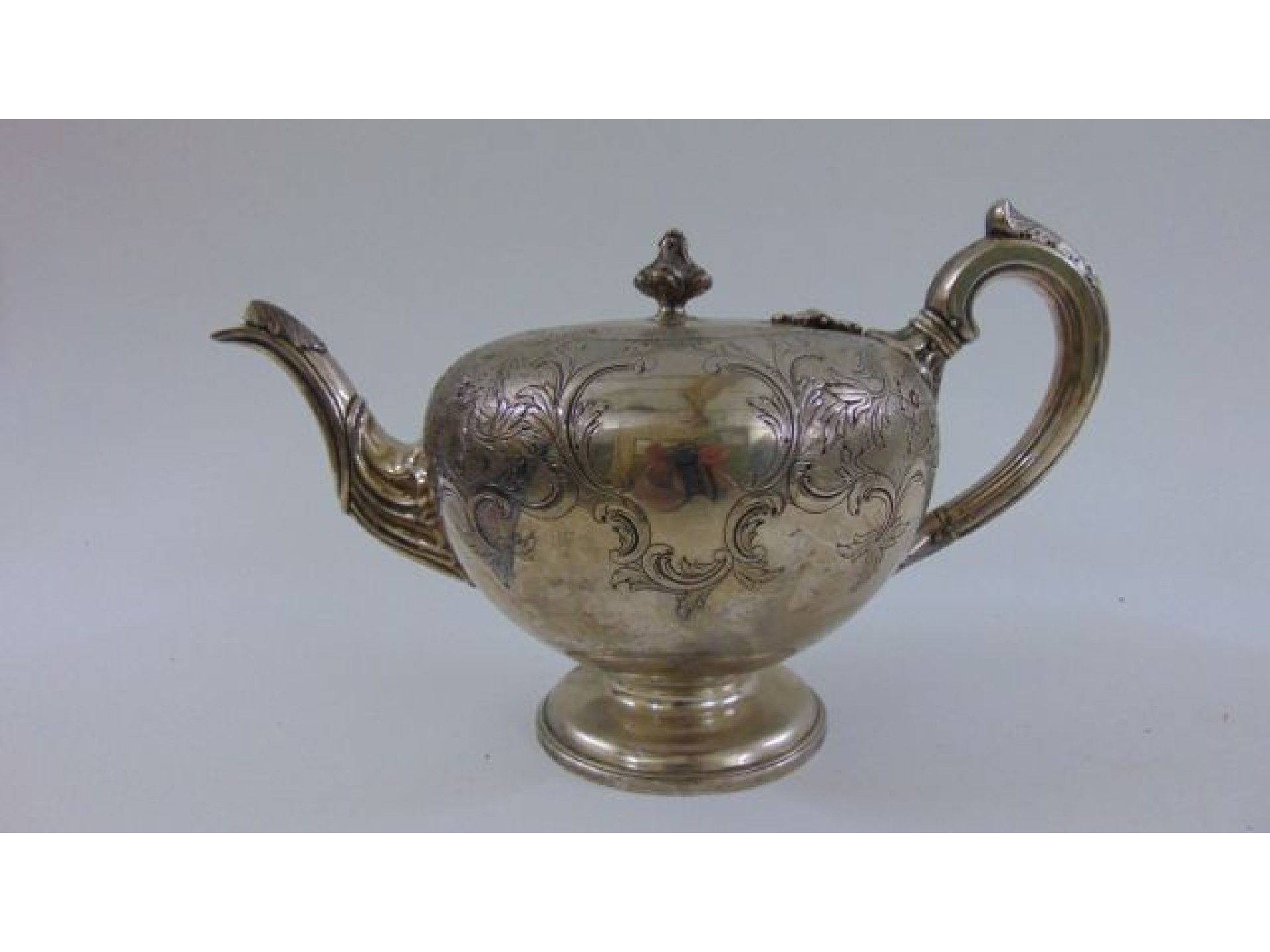 Appraisal: A Victorian silver teapot the body of circular form with