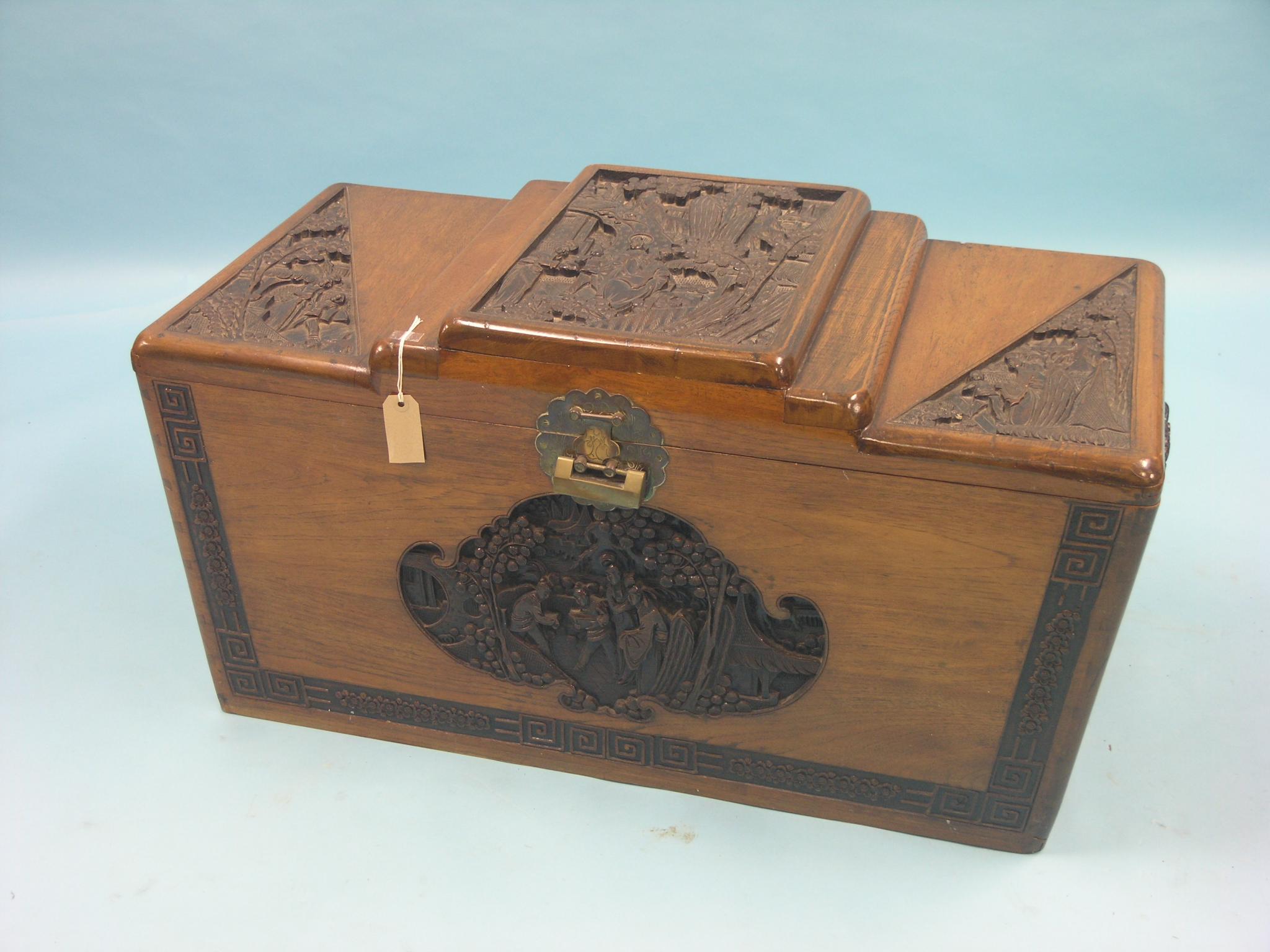 Appraisal: An Oriental camphorwood blanket chest angular design deeply-carved with figures